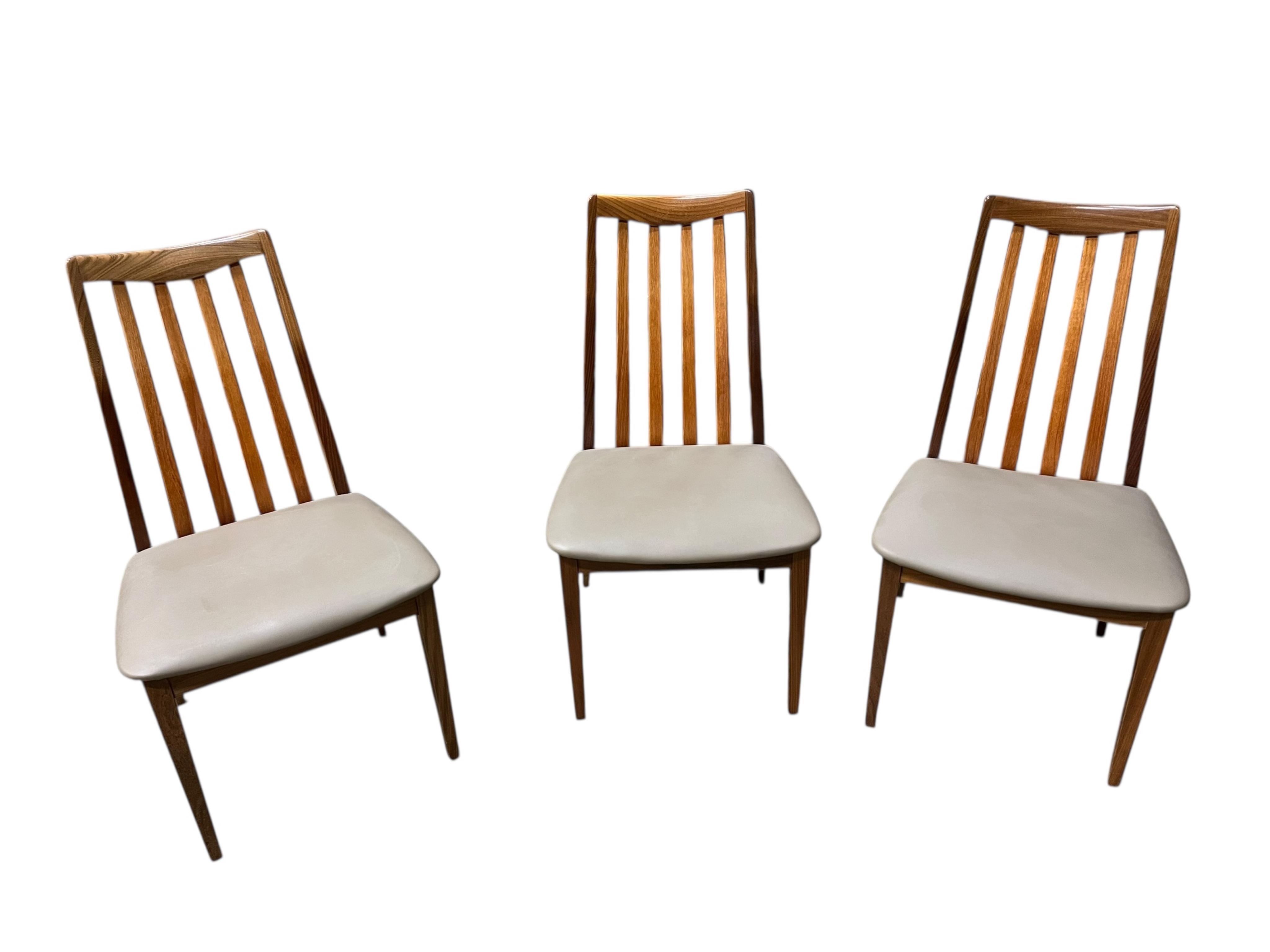 A mid century G Plan Fresco teak dining suite comprising dining table 184cm extended, depth 116cm, height 73cm, six chairs, two with arms and a four door sideboard, width 152cm